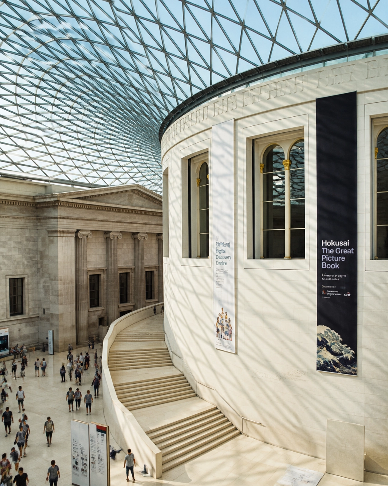 The grand interior of the British Museum featuring sunlit arches and classical architecture